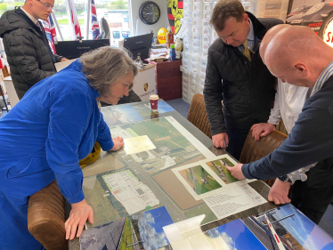Jill Mortimer and Guy Opperman look at plans spread over a table